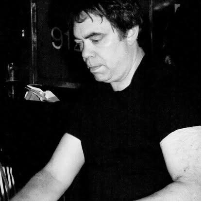 Phil Aiken reading and laughing